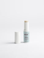Daily Guard SPF 50 stick applied to face — invisible mineral sunscreen for mature skin